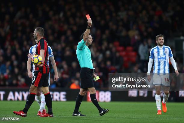 Simon Francis of AFC Bournemouth is shown a red card by referee Lee Probert during the Premier League match between AFC Bournemouth and Huddersfield...