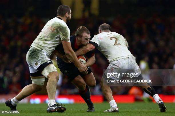 Wales' hooker Kristian Dacey is tackled by Georgia's lock Konstantin Mikautadze and Georgia's hooker Jaba Bregvadze during the international rugby...