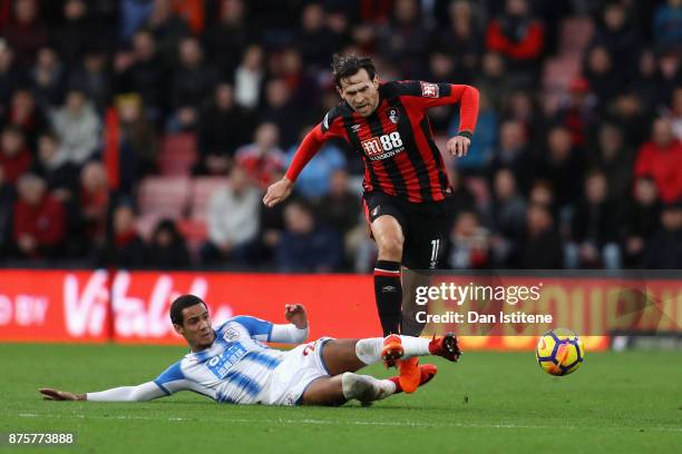 Charlie Daniels of AFC Bournemouth is tackled by Tom Ince of Huddersfield Town during the Premier League match between AFC Bournemouth and...