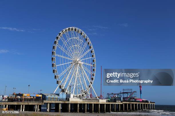 will steel pier's observation wheel on the waterfront in atlantic city, new jersey - steel pier stockfoto's en -beelden