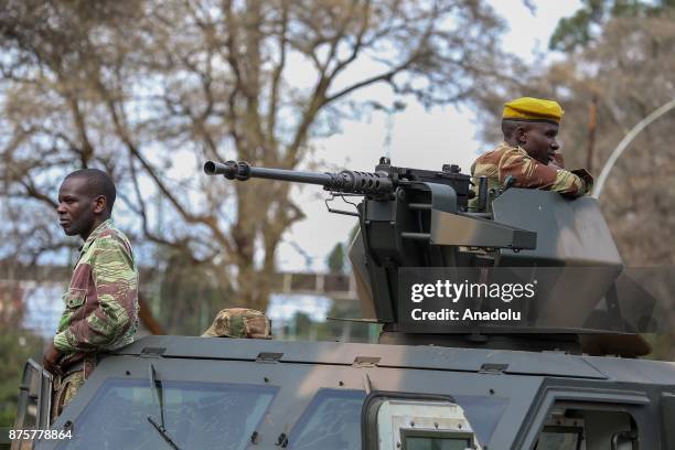 Zimbabwean soldiers take security measures as Zimbabweans march to demand President Robert Mugabe's resignation in Zimbabwe's capital Harare on...