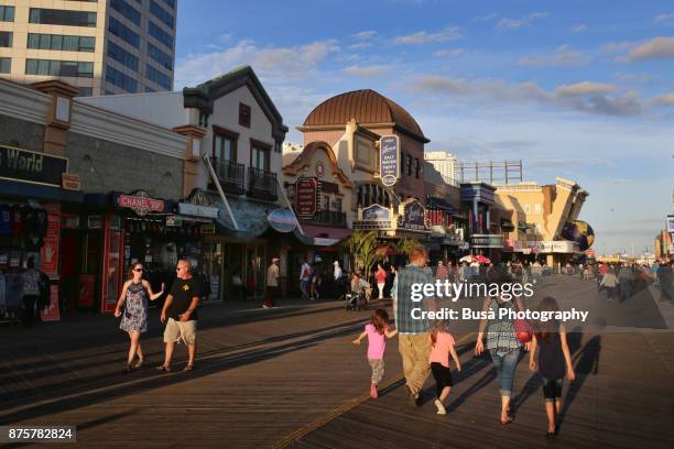 families and couple walking along the atlantic city boardwalk, new jersey - atlantic city fotografías e imágenes de stock