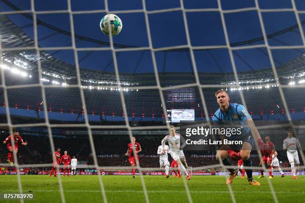 Goalkeeper Bernd Leno of Bayer Leverkusen watches the ball after Emil Forsberg of Leipzig scored a penalty goal to make it 1:2 during the Bundesliga...