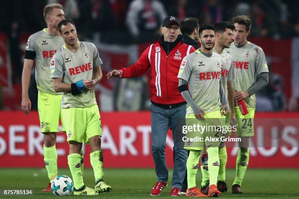 Head coach Peter Stoeger of Koeln comforts his players after the Bundesliga match between 1. FSV Mainz 05 and 1. FC Koeln at Opel Arena on November...