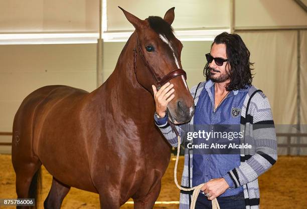 Cuban actor Mario Cimarro attends a guide tour inside the stables prior to the SICAB Closing Gala 2017 on November 18, 2017 in Seville, Spain.