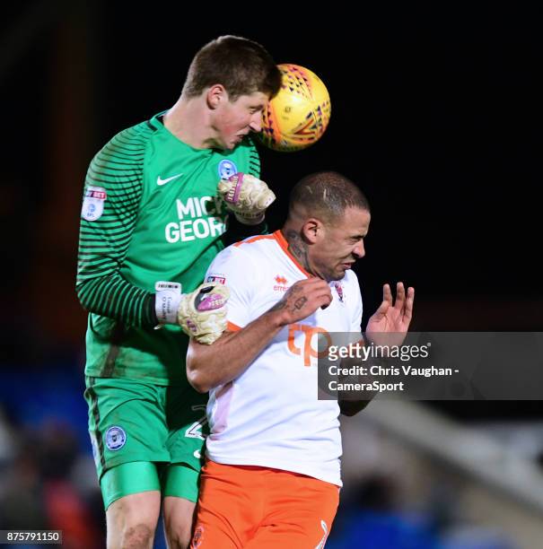 Peterborough United's Conor O'Malley heads the ball clear under pressure from Blackpool's Kyle Vassell during the Sky Bet League One match between...