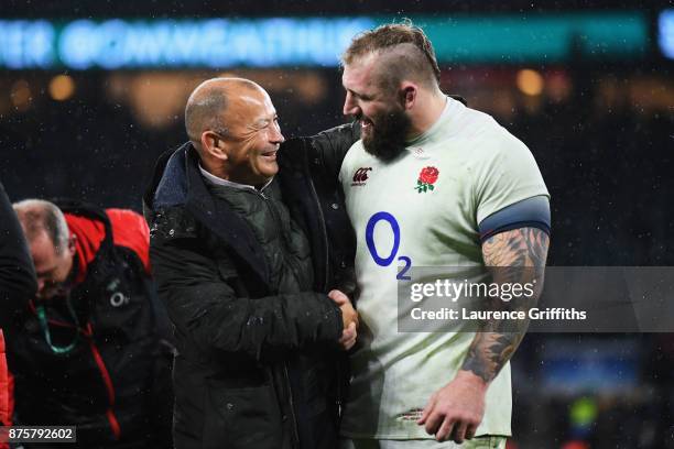 Eddie Jones, head coach of England congratulates Joe Marler of England after the Old Mutual Wealth Series match between England and Australia at...