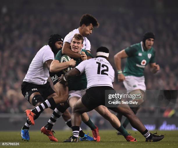 Dublin , Ireland - 18 November 2017; Chris Farrell of Ireland is tackled by Ben Volavola, left, and Levani Botia of Fiji during the Guinness Series...