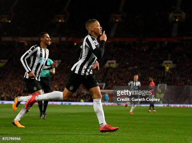 Dwight Gayle of Newcastle United celebrates with team mates after scoring his sides first goal during the Premier League match between Manchester...