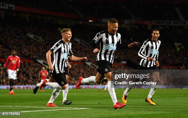 Dwight Gayle of Newcastle United celebrates with team mates after scoring his sides first goal during the Premier League match between Manchester...