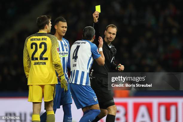 Referee Bastian Dankert awards Moenchengladbach a penalty following video referee check, and shows Karim Rekik of Berlin a yellow card fo a hand...