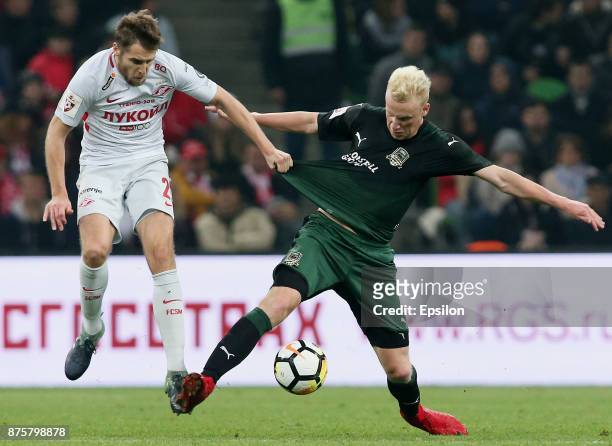 Vyacheslav Podberezkin of FC Krasnodar vies for the ball with Dmitri Kombarov of FC Spartak Moscow during the Russian Premier League match between FC...
