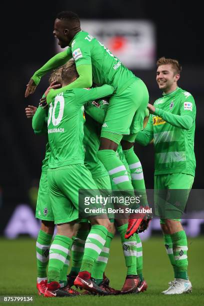 Raffael of Moenchengladbach is celebrated by his team after he scored a goal to make it 3:0 during the Bundesliga match between Hertha BSC and...