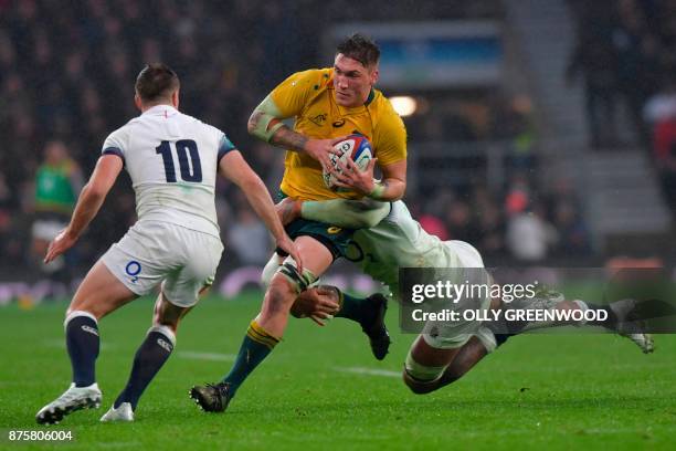 Australia's number 8 Sean McMahon is tackled by England's lock Courtney Lawes during the international rugby union test match between England and...