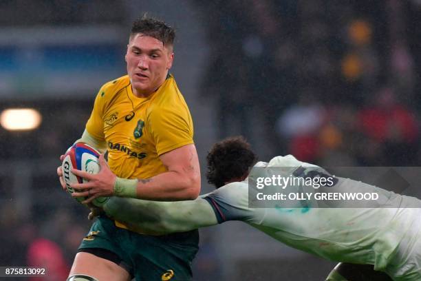 Australia's number 8 Sean McMahon is tackled by England's lock Courtney Lawes during the international rugby union test match between England and...