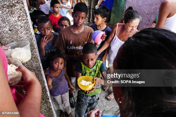 Boy seen carrying out his food. Children wait for food in soup kitchens that provides free food on the streets to counteract the food crisis...