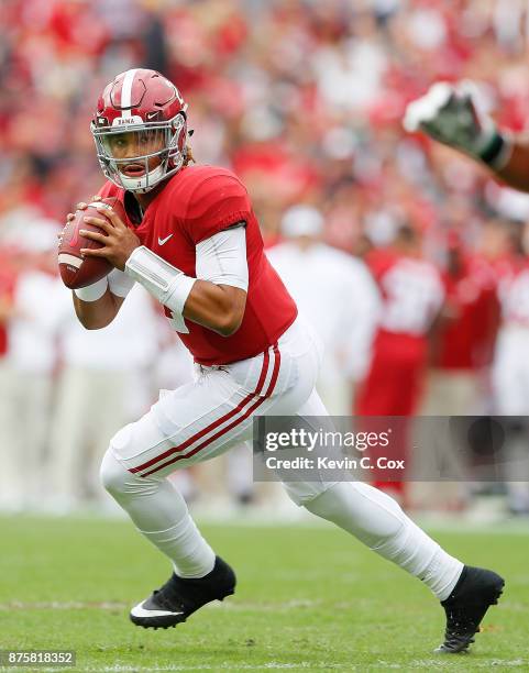 Jalen Hurts of the Alabama Crimson Tide rolls out to pass against the Mercer Bears at Bryant-Denny Stadium on November 18, 2017 in Tuscaloosa,...