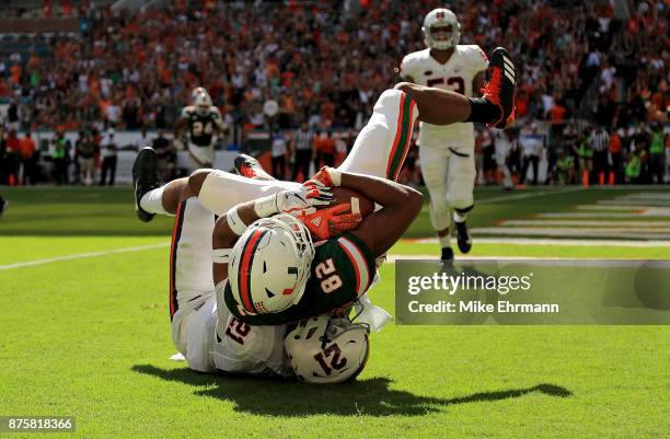 Ahmmon Richards of the Miami Hurricanes makes a touchdown catch over Juan Thornhill of the Virginia Cavaliers during a game at Hard Rock Stadium on...