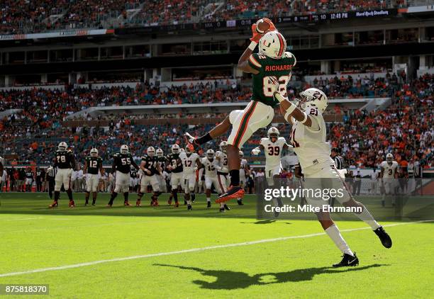 Ahmmon Richards of the Miami Hurricanes makes a touchdown catch over Juan Thornhill of the Virginia Cavaliers during a game at Hard Rock Stadium on...