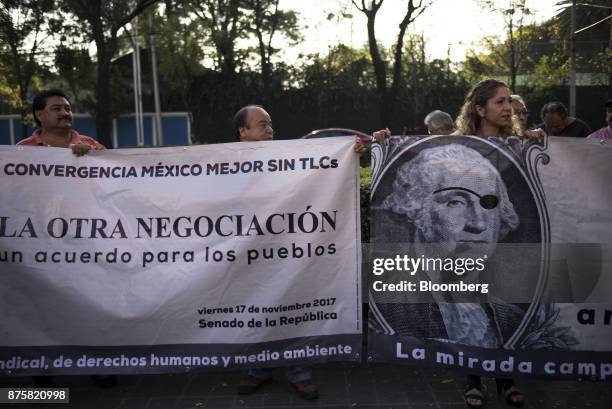 Demonstrators hold banners during a protest ahead of the North American Free Trade Agreement renegotiations in Mexico City, Mexico, on Friday, Nov....