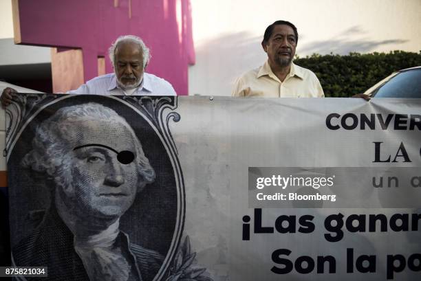 Demonstrators hold banners during a protest ahead of the North American Free Trade Agreement renegotiations in Mexico City, Mexico, on Friday, Nov....