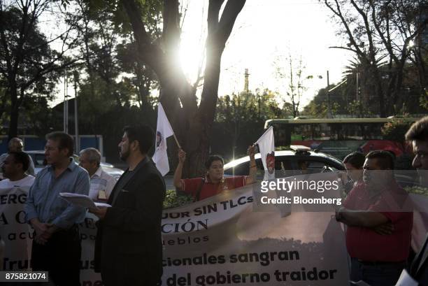 Demonstrators from the mine workers union hold flags and a banner during a protest ahead of the North American Free Trade Agreement renegotiations in...