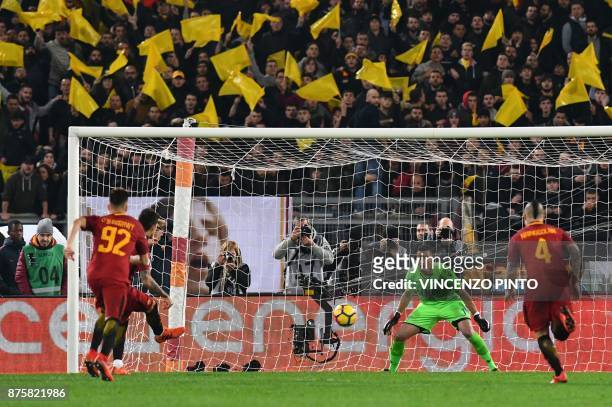 Roma's Argentinian midfielder Diego Perotti scores against Lazio's goalkeeper from Albania Thomas Strakosha during the Italian Serie A football match...