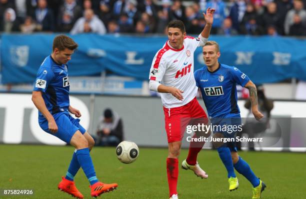 Bjoern Rother of Magdeburg tackles Markus Pazurek of Cologne during the 3. Liga match between SC Fortuna Koeln and 1. FC Magdeburg at Suedstadion on...