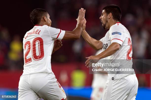 Sevilla's Colombian forward Luis Muriel celebrates a goal with Spanish forward Nolito during the Spanish league football match Sevilla vs Celta Vigo...