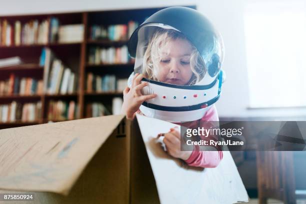 children imagine space adventure in cardboard box - child drawing job imagens e fotografias de stock