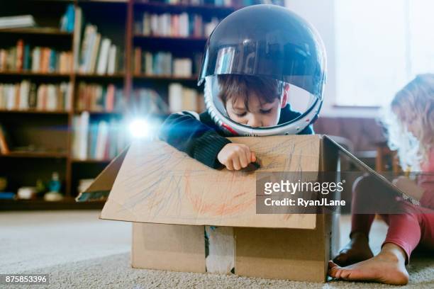 Children Imagine Space Adventure in Cardboard Box