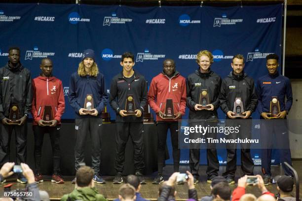 Eight of the top 13 runners stand at the podium with their awards following the Division I Men's Cross Country Championship held at E.P. Tom Sawyer...