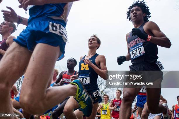 Aaron Baumgarten of the University of Michigan and George Espino of Southern Utah University compete during the Division I Men's Cross Country...