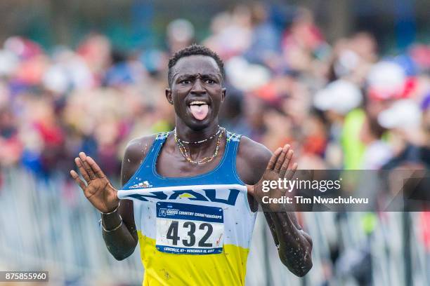 Peter Lomong of Northern Arizona University pops out his uniforms en route to the finish line during the Division I Men's Cross Country Championship...