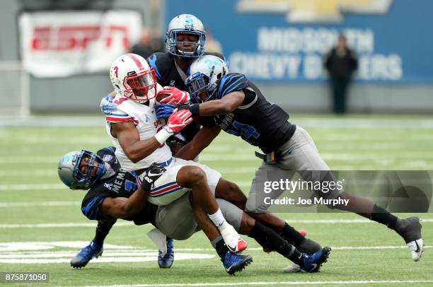 James Proche of the SMU Mustangs is tackled by Jonathan Cook and Tito Windham of the Memphis Tigers on November 18, 2017 at Liberty Bowl Memorial...