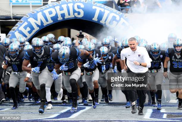 Mike Norvell, Head coach of the Memphis Tigers leads his team on the field before a game against the SMU Mustangs on November 18, 2017 at Liberty...