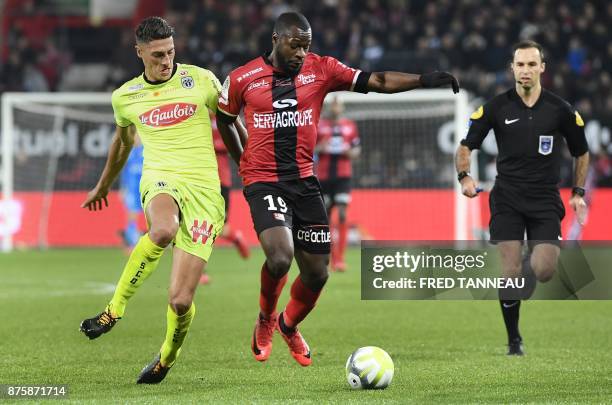 Guingamp's French midfielder Yannis Salibur vies with Angers's Algerian defender Mehdi Tahrat during the French L1 football match Guingamp vs Angers...