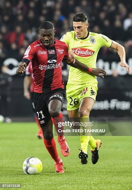 Guingamp's French midfielder Marcus Thuram outruns Angers's Algerian defender Mehdi Tahrat during the French L1 football match Guingamp vs Angers on...