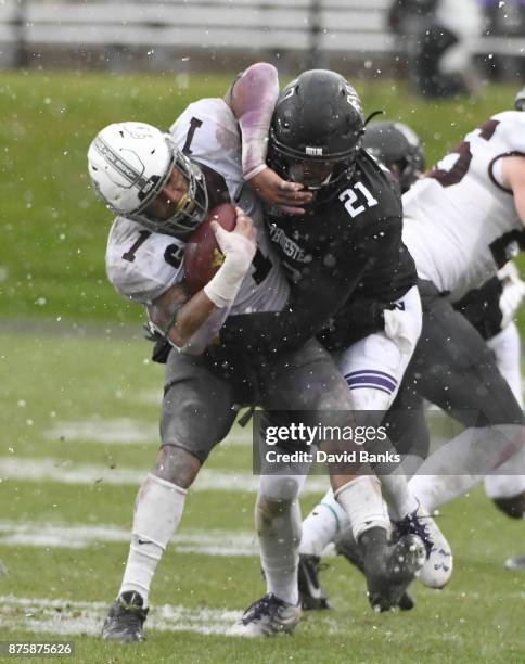 Kyle Queiro of the Northwestern Wildcats tackles Rodney Smith of the Minnesota Golden Gophers during the second half on November 18, 2017 at Ryan...