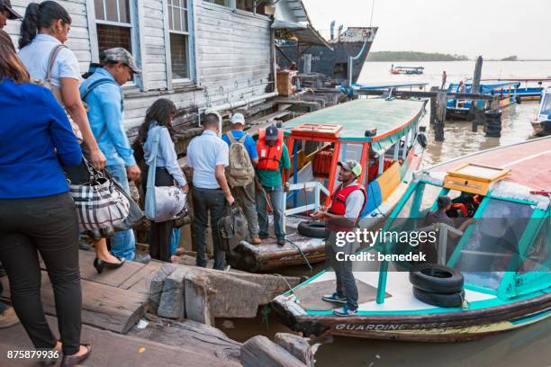 commuters board passenger boats in georgetown guyana - guyana stock pictures, royalty-free photos & images