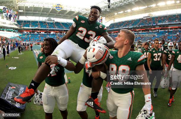 Christopher Herndon IV of the Miami Hurricanes is carried off the field after winning a game against the Virginia Cavaliers at Hard Rock Stadium on...