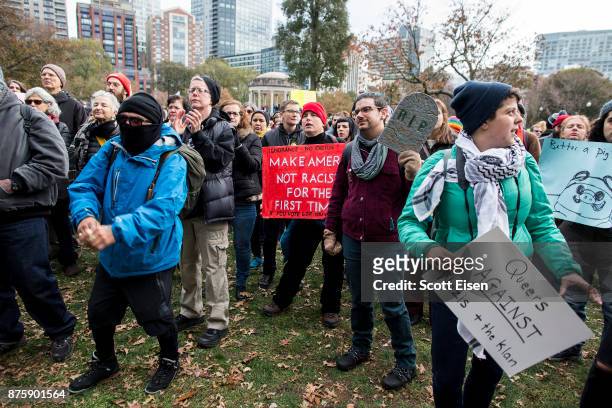 Counter-protesters of an Alt-Right organized free speech event chant and hold up signs on the Boston Common on November 18, 2017 in Boston,...
