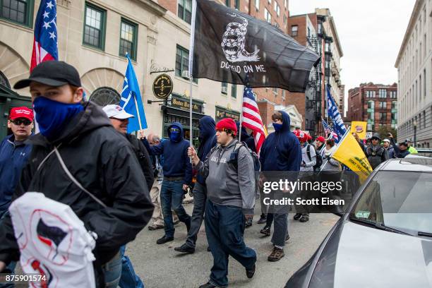 Participants of an Alt-Right organized free speech event march from the Boston Common back to their vehicles on November 18, 2017 in Boston,...