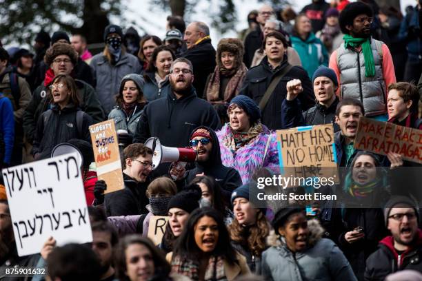 Counter-protesters of an Alt-Right organized free speech event chant and hold up signs on the Boston Common on November 18, 2017 in Boston,...