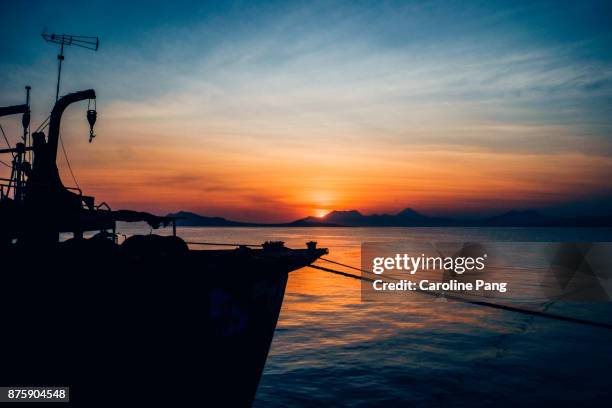 magical hour at the port of ende in flores, indonesia. - caroline pang bildbanksfoton och bilder