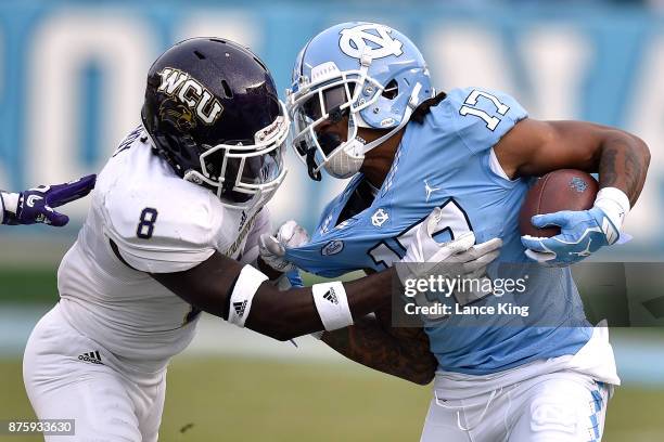 Anthony Ratliff-Williams of the North Carolina Tar Heels tries to avoid a tackle by Tra Hardy of the Western Carolina Catamounts at Kenan Stadium on...