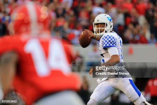 Stephen Johnson of the Kentucky Wildcats throws a pass on the run during the first half against the Georgia Bulldogs at Sanford Stadium on November...