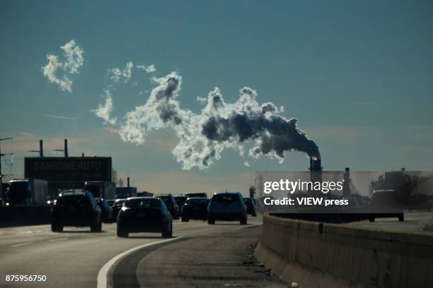 Vehicles move along the The New Jersey Turnpike Way while a Factory emits smoke on November 17, 2017 in Carteret, New Jersey. The United States is...