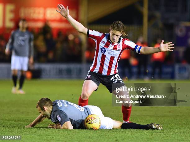 Coventry City's Michael Doyle shields the ball from Lincoln City's Alex Woodyard during the Sky Bet League Two match between Lincoln City and...
