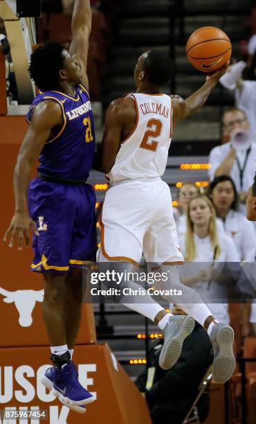 Matt Coleman of the Texas Longhorns shoots the ball against Kenny Cooper of the Lipscomb Bisons at the Frank Erwin Center on November 18, 2017 in...